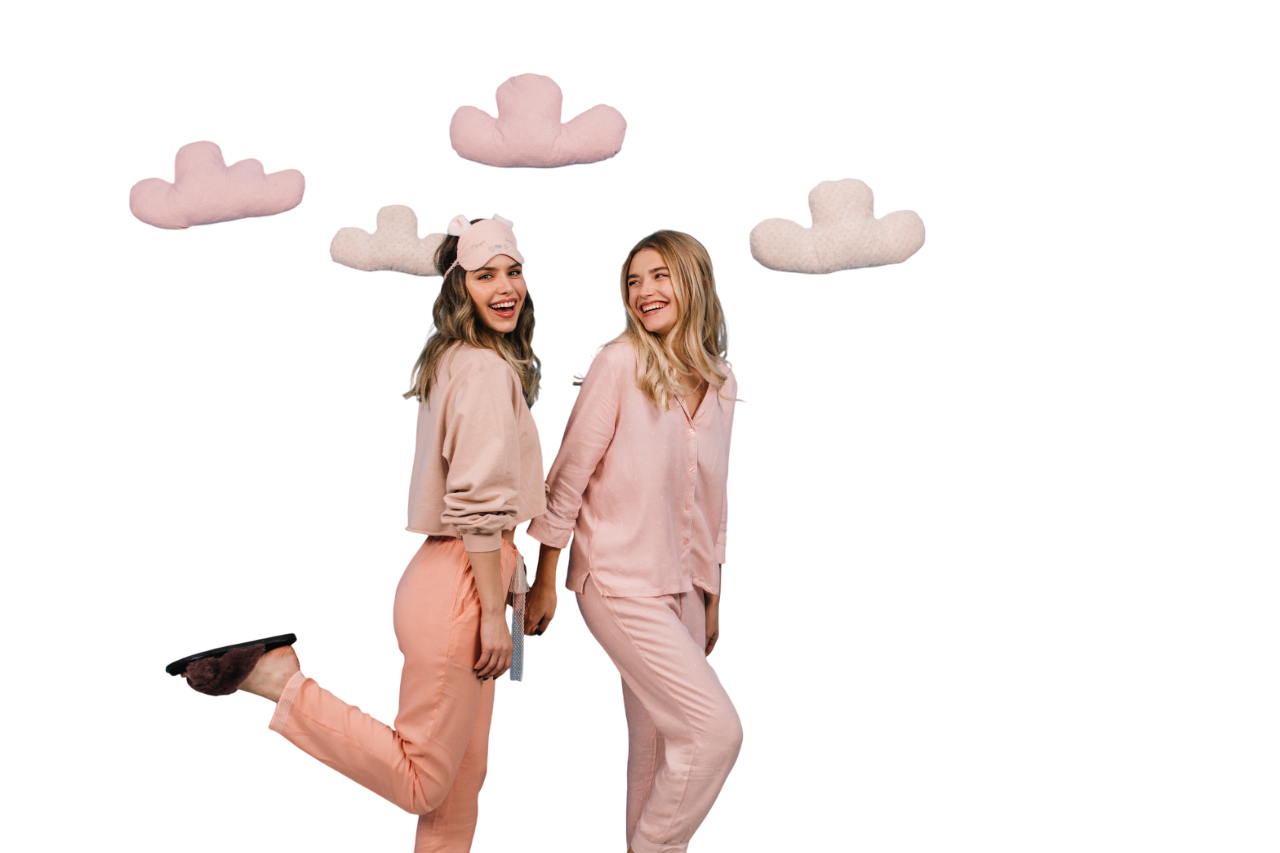 studio-shot-women-pajamas-standing-blue-wall-with-toy-clouds-Photoroom