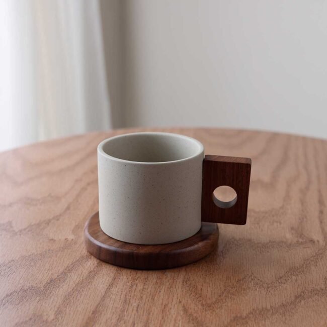 Ceramic mug with wooden coaster