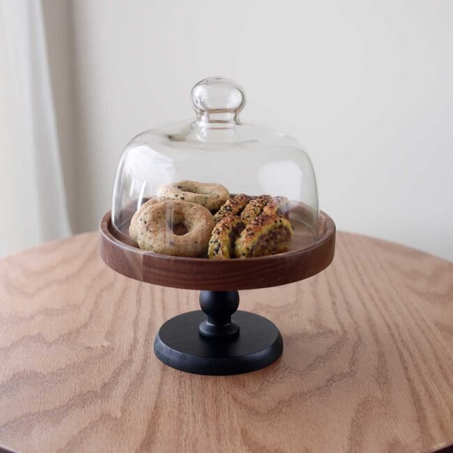 Large Acacia wood hostess with black stand and glass cover