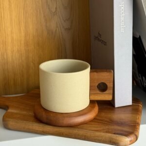 Ceramic mug with wooden coaster